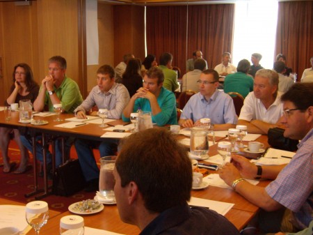 Members of GIGA sit around a table discussing processes and techniques